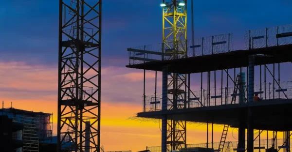 A construction site with a crane at sunset