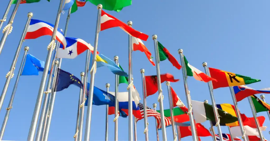 Flags from many countries against a blue sky