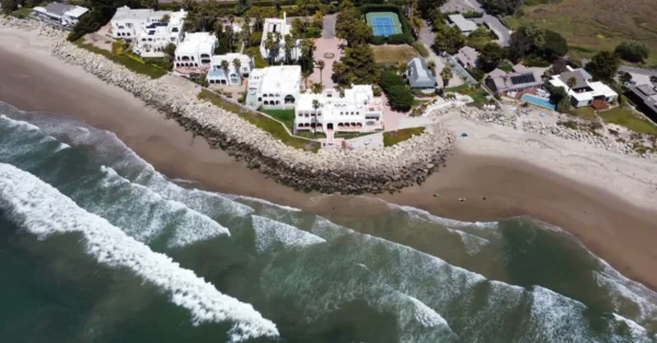 Arial view of large homes along a stretch of beach.