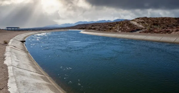 Image of California aqueduct with storm looming in background. 