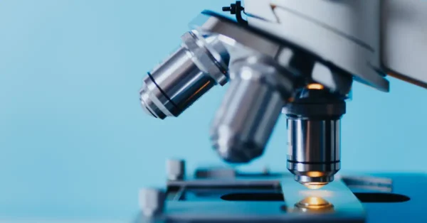 Close up image of a microscope, to represent research and development efforts