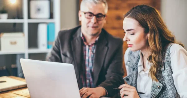 A male and female accountant engaged in a discussion, representing valuable one-on-one time with partners.