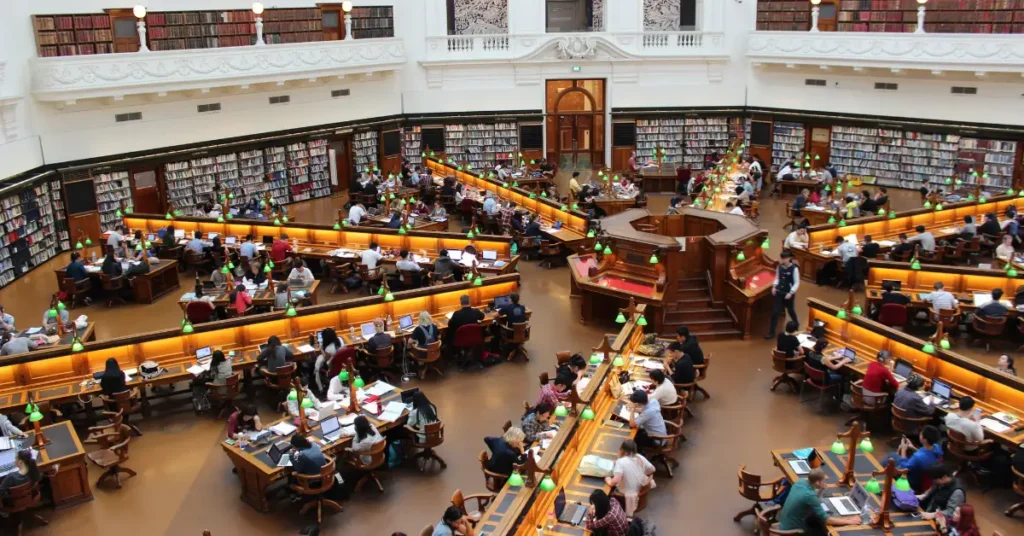 College students studying in a large, circular university library