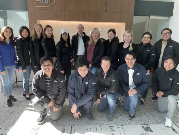 Antonia Kempfer with her teammates at JLK Rosenberger's office in Glendale, California. The team members are all wearing JLK Rosenberger jackets. 