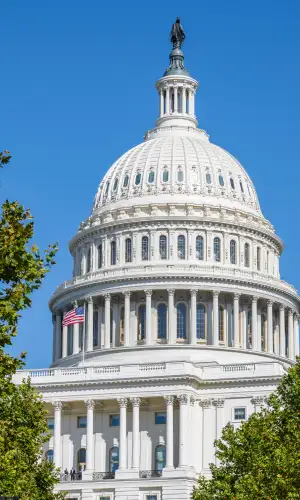 Close up image of the US Capitol against a blue sky.